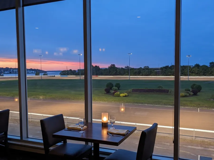 Window table above the Red Shores oval at dusk